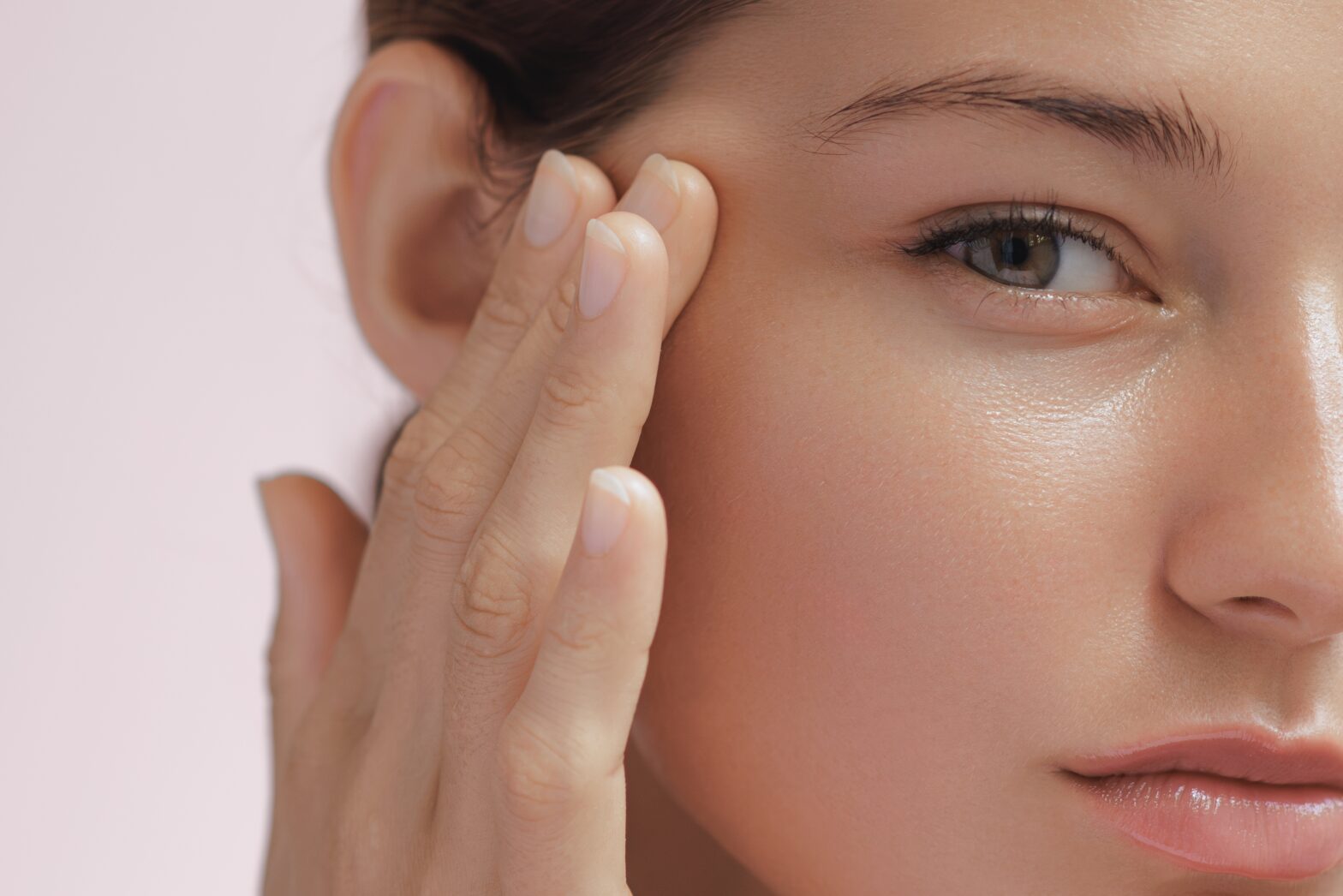 Extreme close up of women touching face with clear skin